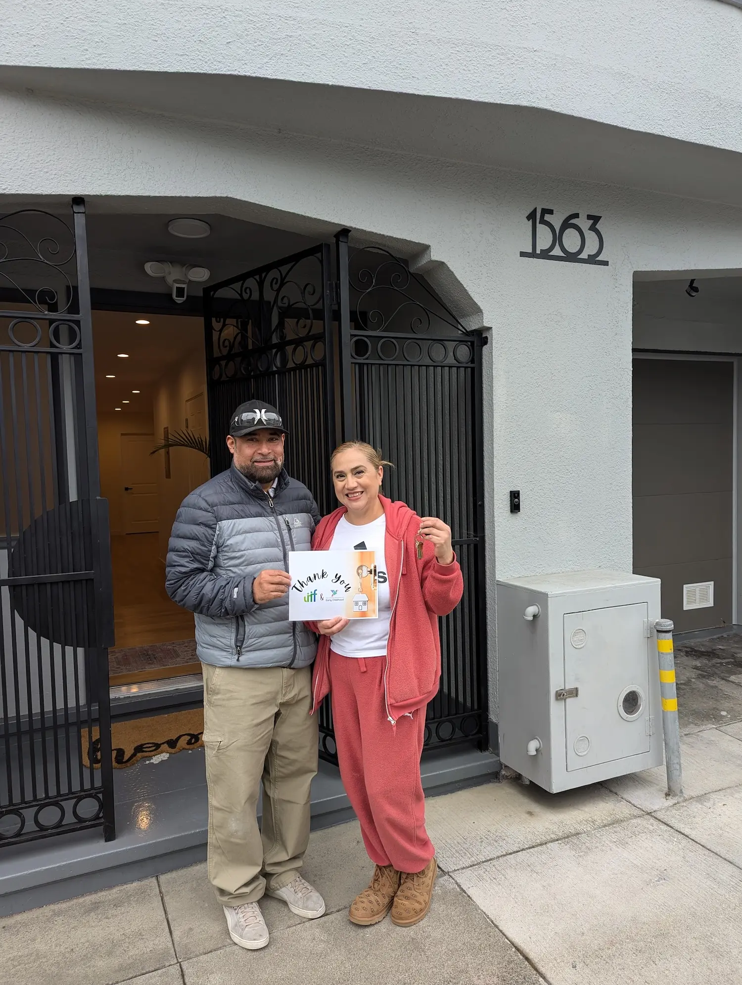 A man and woman hold a sign that says Thank You LIIF.