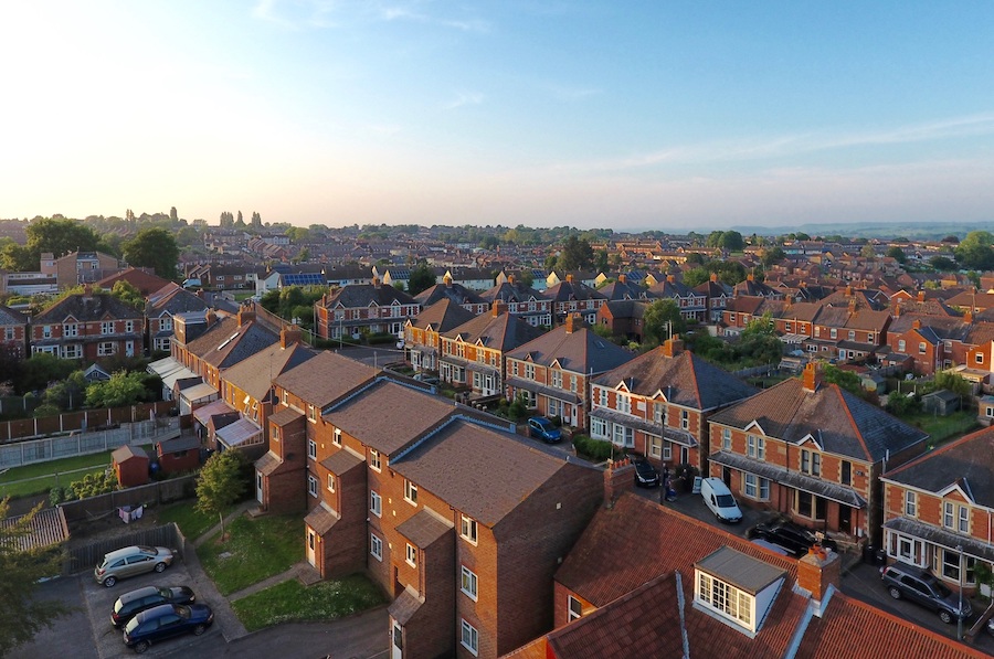 Birds-eye view of suburbs on the outskirts of a major city.