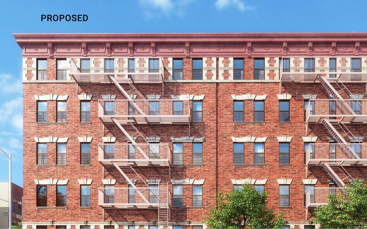 Front of a brick building with prominent fire escapes.