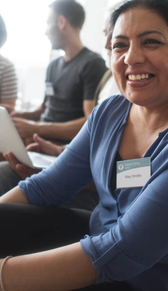 Woman with name tag smiling